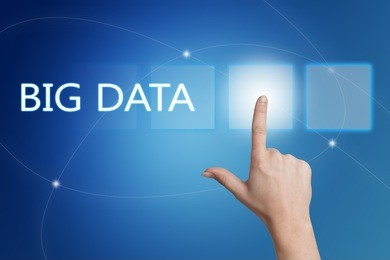 big data - hand pressing button on interface with blue background.
