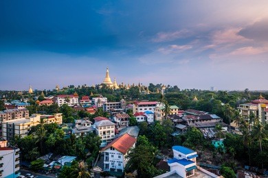 shwedagon pagoda during the day with blue skies