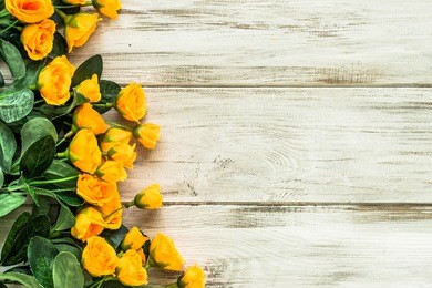 beautiful flowers frame with roses on wood.