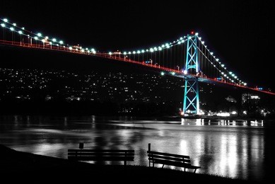 night scene of lions gate in bc canada. it's a black and white photo, beside, the whole bridge.
