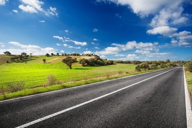 road through the green field of sardinia countryside in sunny day