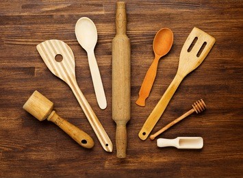 wooden kitchen tools on vintage wooden background. top view.
