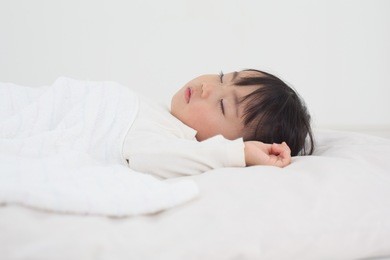 asian kid having nap time.