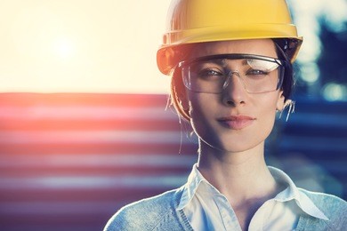 beautiful woman civil engineer close up portrait in front of a sunset background
