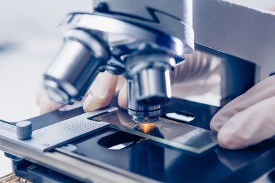 scientist hands with microscope close-up shot in the laboratory