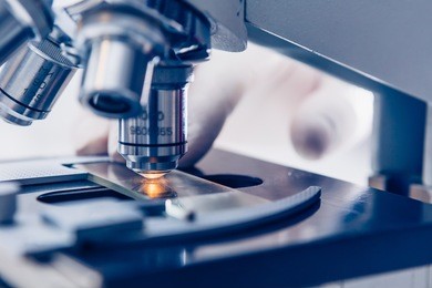 scientist hands with microscope close-up shot in the laboratory