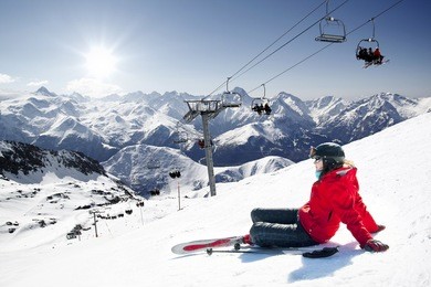 girl skier lying on snow with ski,  french alps high mountain