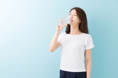 young attractive asian woman who drinks water