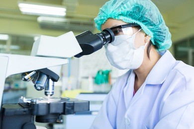 scientist using a microscope in a laboratory