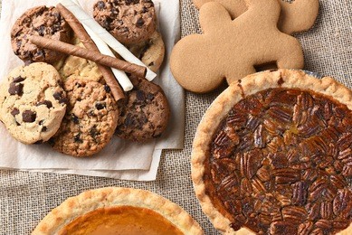 assorted holiday desserts including:  gingerbread, pumpkin and pecan pie, chocolate chip and oatmeal raisin cookies, 