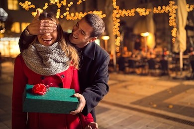 man  keeps his girlfriend eyes covered while  she giving a gift , romantic surprise for christmas
