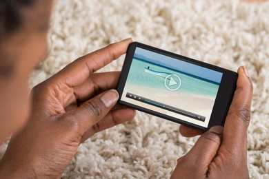 close-up of person watching video on mobile phone