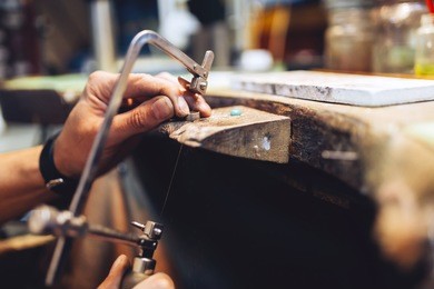 jeweler using saw to create jewelry
