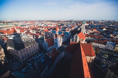 beautiful super wide-angle sunny aerial view of munich, bayern, bavaria, germany with skyline and scenery beyond the city, seen from the observation deck of st. peter church
