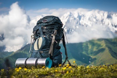 tourist backpack and sleeping pad on a background of mountains, georgia (svaneti)