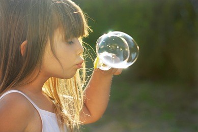 blowing soap bubbles