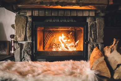 warm cozy fireplace with real wood burning in it. cozy winter concept. christmas and travel background with space for your text.
