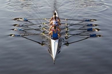 rowers paddling in a beautiful italian lake