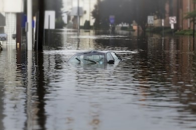 a flooded car in deep water.