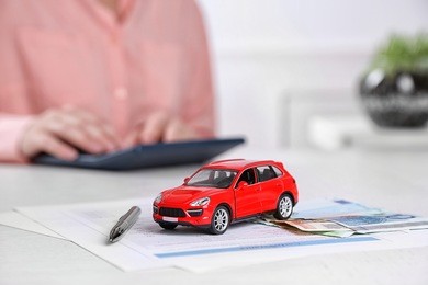 toy car and documents on table. car insurance concept