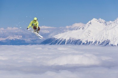 flying skier on mountains. extreme winter sport.