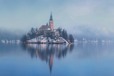 foggy evening on bled lake at winter in slovenia