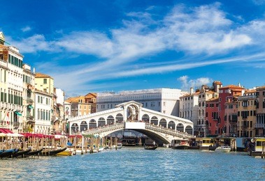 gondola at the rialto bridge in venice, in a beautiful summer day in italy