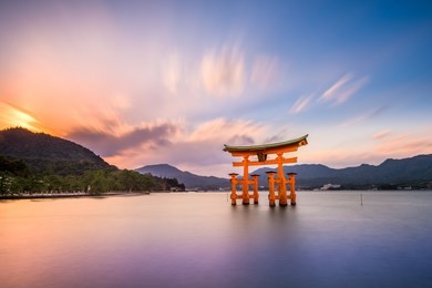 miyajima, hiroshima, japan at the floating gate of itsukushima shrine. (gate sign reads itsukushima shrine)