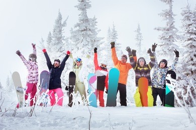 group of friends skiers and snowboarders having fun on snowbound winter forest. sheregesh resort, siberia, russia