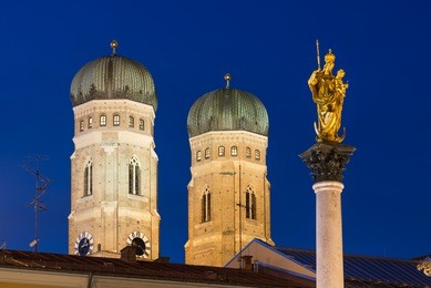 towers of frauenkirche (cathedral of our dear lady) with mary's column at night, munich, bavaria, germany