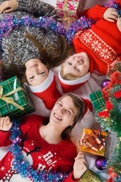 happy brother and sisters is near a christmas tree. children waiting for the new year