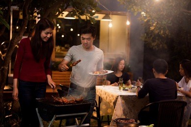 asian are doing barbecues and party at night