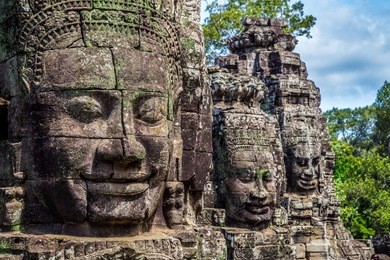 buddhist faces on towers at bayon temple, cambodia.