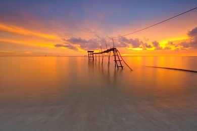 beautiful long exposure shot of fishermen jetty at dusk. soft focus due to long exposure shot. vibrant colors. composition of nature.