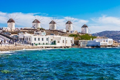 iconic windmills viewpoint during a clear and bright summer sunny day, mykonos, greece