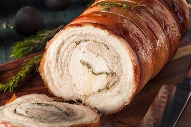 homemade rolled porchetta roast with several herbs