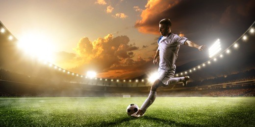soccer player in action on sunset stadium background