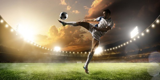 soccer player in action on sunset stadium background