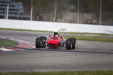 a red racing car running in the circuit of monza, italy