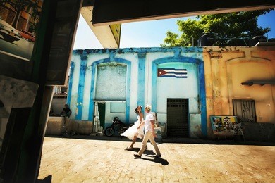 happy wedding couple walking holding hands in old city of havana