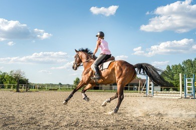 young woman riding a horse 