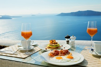 fresh juice and  breakfast on the shore of the blue sea, greece, santorini.