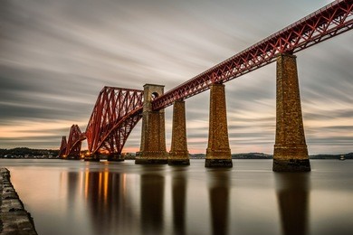 forth railway bridge over the firth of forth at sunset in edinburgh, scotland, united kingdom. long exposure.