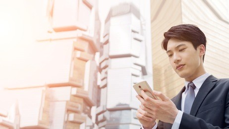 confident young asian businessman using cellphone, concept of business, technology, social media etc.