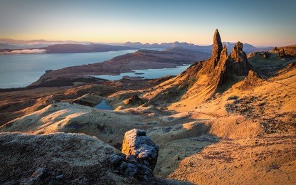first beams of light at sunrise over old man of storr, isle of skye, scotland, uk