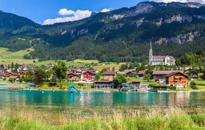 stunning view of the small town lungern on the lake side of lungernsee on bernese oberland of switzerland. this town lies on the railway line between lucerne and interlaken.