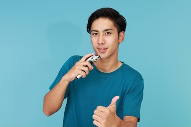 a man shaving with electric razor