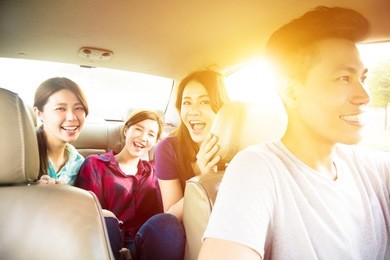 young group people enjoying road trip in the car