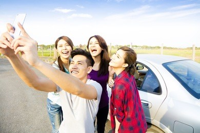 young  people enjoying road trip  and making selfie