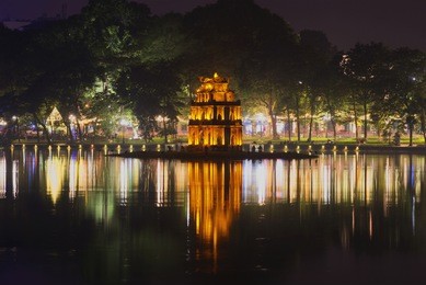 the turtle tower on the background of night the promenade of the lake of restored sword. hanoi, vietnam